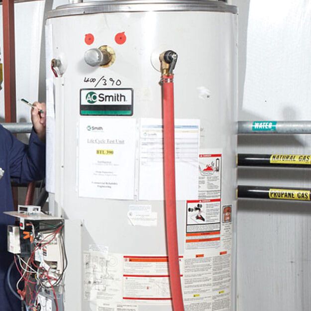 man inspecting water heater man inspecting water heater