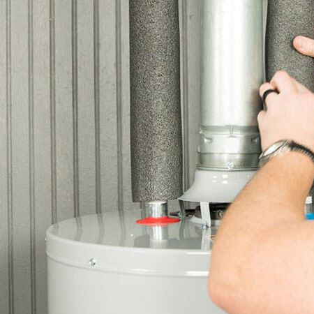 Plumber fixing a water heater Plumber fixing a water heater