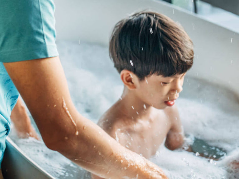 Father bathing child in tub Father bathing child in tub