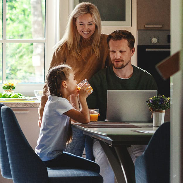 family smiling at kitchen table family smiling at kitchen table